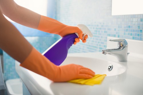 Professional carpet cleaner in Uxbridge treating a living room carpet