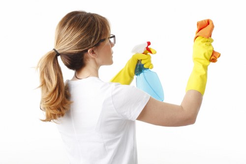 Uxbridge domestic cleaner wiping kitchen counters and sanitising high-touch surfaces
